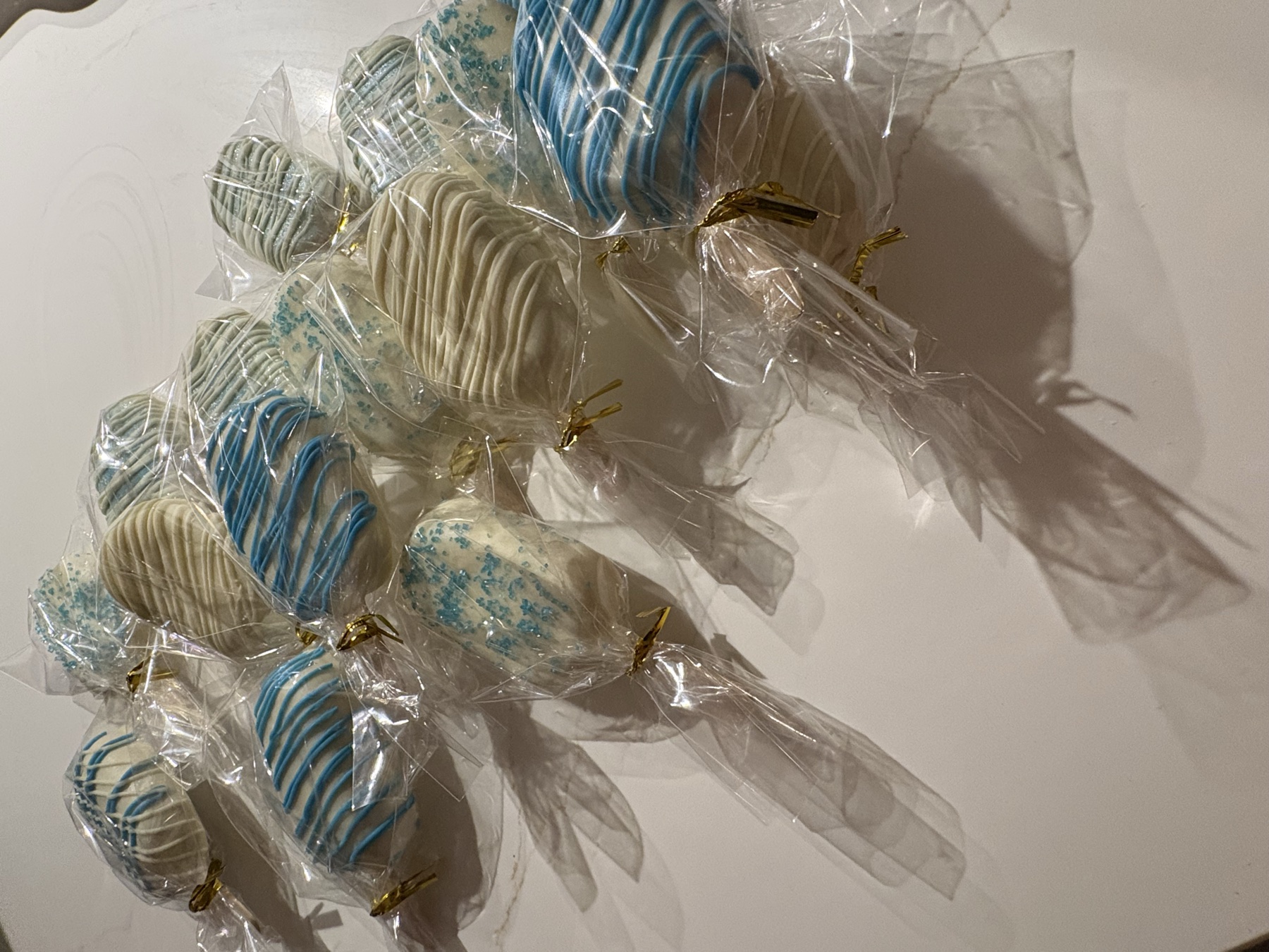 An assortment of blue and white handmade cake pops